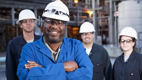 4 industrial workers wearing hard hats