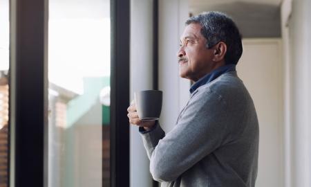 Side profile of man holding mug