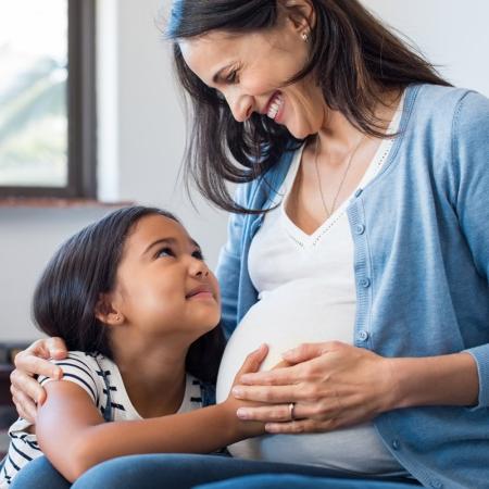 Pregnant Woman and child holding belly